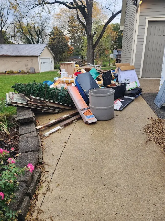 Dumpster being loaded with debris for 12 Yard Dumpster Rental in Madeira